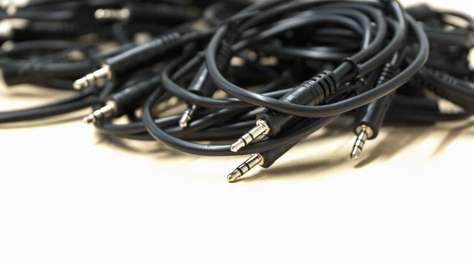 A pile of 3.5 mm aux cables