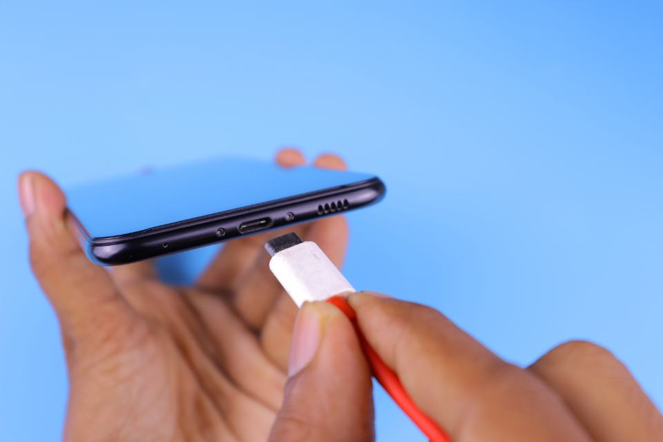 A USB-C cable being plugged into a phone